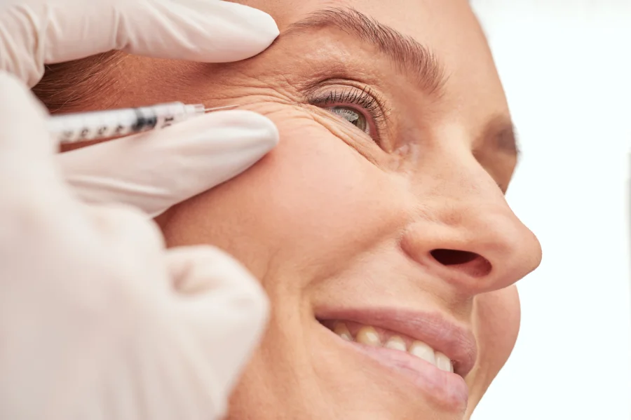 Envato. - Beauty procedure. Close up of a beautiful mature woman receiving hyaluronic acid injection by beautician. Skin care and cosmetology concept
